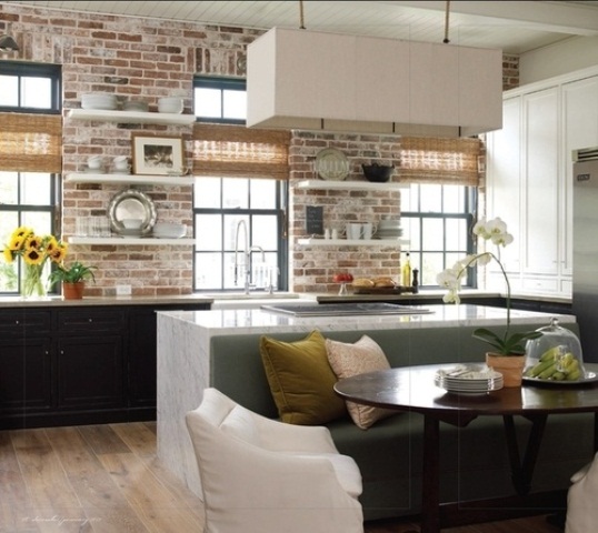 whitewashed red brick, wicker shades and stone countertops are great to spruce up the kitchen making it bolder