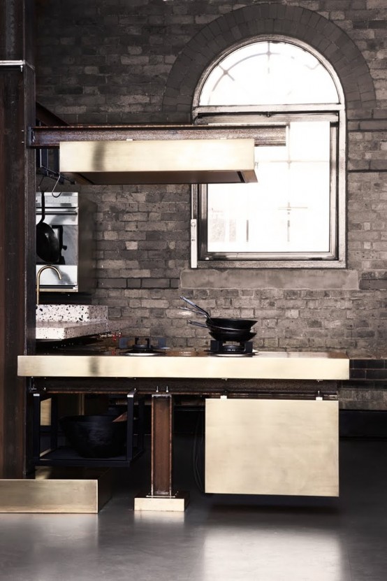 a taupe brick wall makes the luxurious kitchen less formal and more relaxed at the same time