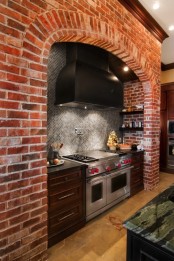 a red brick cooker backsplash with shelves and grey tiles make up the space chic and textural
