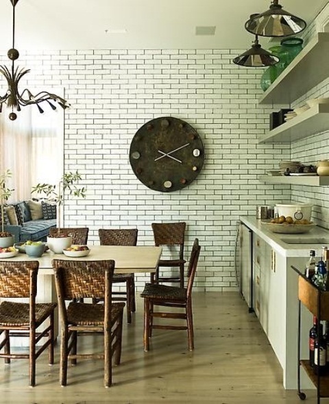 a faux brick wall in the dining space add interest and texture to the space making it catchier