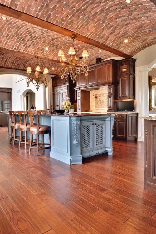 an arched red brick ceiling with wooden beams and rich stained wooden cabinets create a gorgeous space with an elegant vintage feel