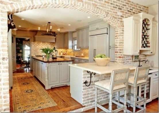 whitewashed bricks and neutral tiles make up a stylish kitchen with a rustic and vintage feel