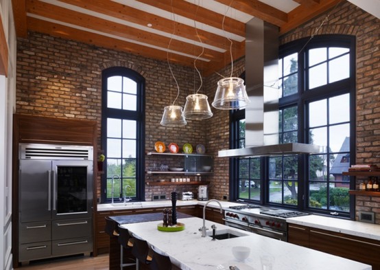 a dark kitchen with red brick walls and arched windows plus refined rich stained furniture
