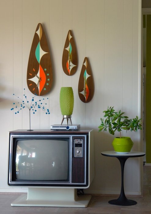 bright plywood artworks and clocks, potted greenery, vases and a retro TV to add a real retro touch to the living room