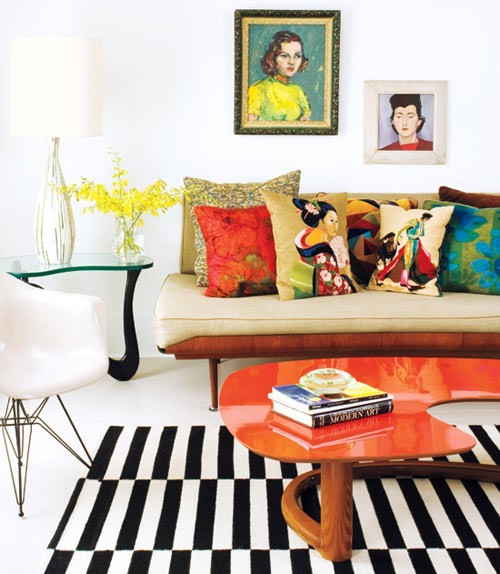 a bright mid-century modern living room with elegant furniture, bright artworks, colorful and printed pillows
