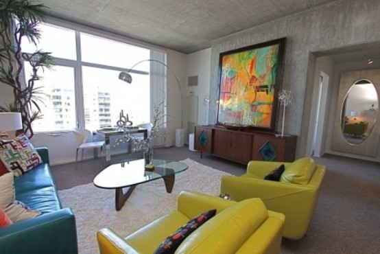 concrete walls, floor and ceiling are complemented with colorful furniture and bright artworks