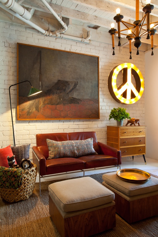 an eclectic living room with industrial touches, mid-century modern furniture and creative artworks