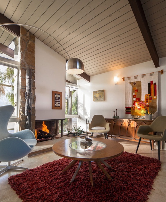 a neutral living room with blue, burgundy, red, beige touches, lamps and a cozy fireplace