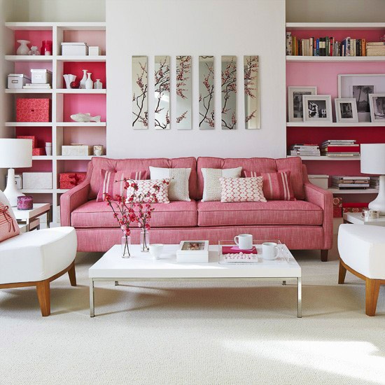 a pink and white mid-century modern living room with built-in shelves with backing and floral artworks