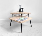 a mid-century modern two-tiered coffee table in neutrals and with black legs is a stylish idea for both storage and displaying objects