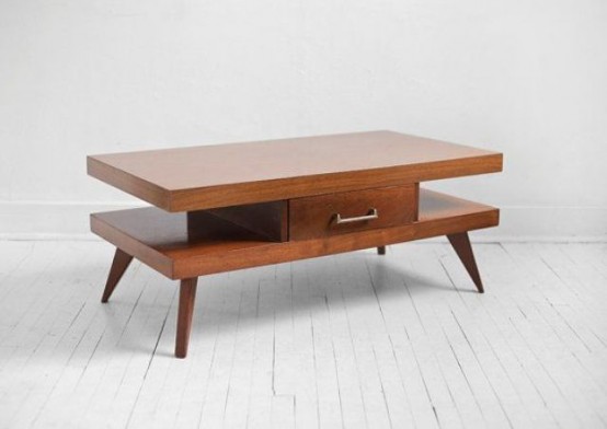 a rich-stained mid-century modern coffee table with two tabletops, a small drawer for hiding stuff