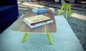 a bold mid-century modern styled coffee table with a plywood tabletop and neon yellow tapered legs will add a touch of fun to the space