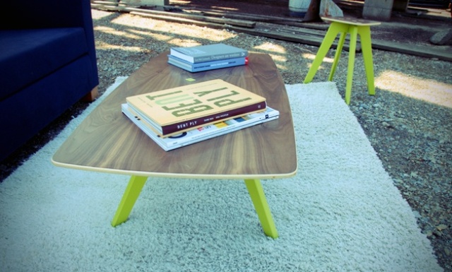a bold mid century modern styled coffee table with a plywood tabletop and neon yellow tapered legs will add a touch of fun to the space