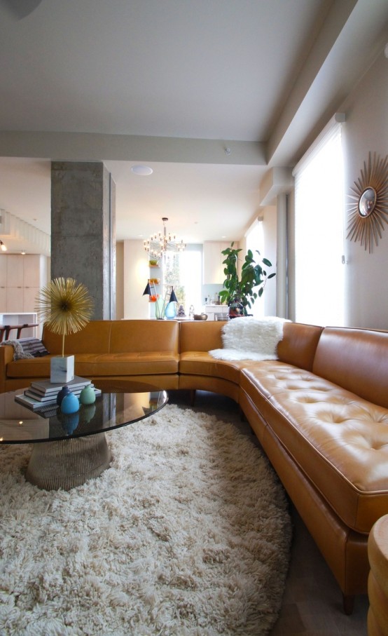 a refined glass and metal mid-century modern coffee table with a dark glass tabletop and an ethereal metal base is wow