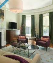 a refined art-deco inspired coffee table with a black oval tabletop and cool gold geometric legs is a bold idea that will accent your living room