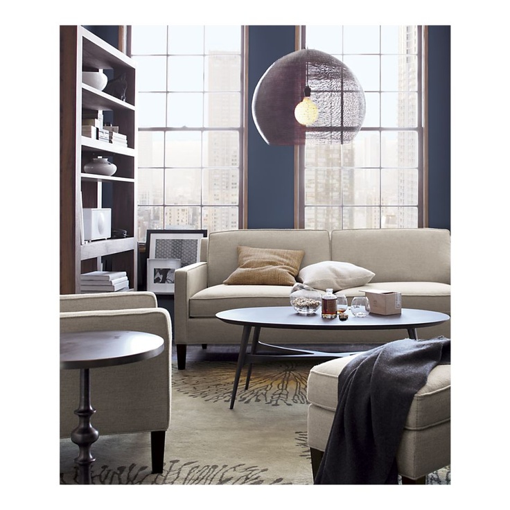 a dark stained oval coffee table with classic legs and a criss cross touch is a stylish and elegant solution