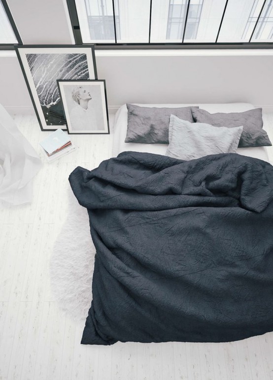 a minimalist meets Scandinavian bedroom with several windows, a bed with grey and white bedding and some artwork right on the floor is cool