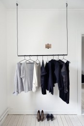 a very laconic and minimal closet of a simple holder for clothes hangers and nothing else is very sustainable and very cool