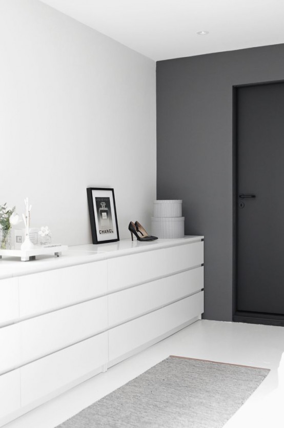 an ultra-minimalist closet done in white, with several dressers that look sleek and chic