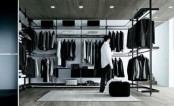 a minimalist masculine closet done with lots of hanger holders and some open shelves plus a couple of baskets