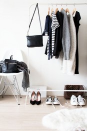 a white makeshift closet and a stool are all you need for a small wardrobe, the space feels Scandinavian
