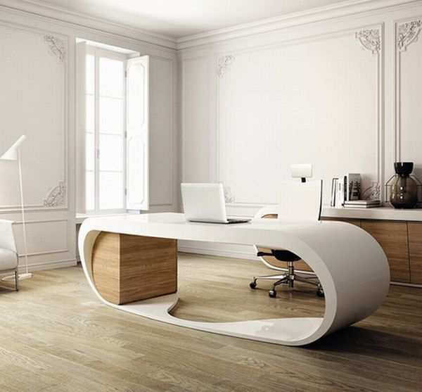 a refined minimalist home office in white and light stained wood, with a statement curved desk, a storage unit with countertop, a floor lamp and a white chair