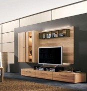 a modern light-stained plywood TV unit plus a wall-mounted part with lights and a cabinet attached on one side