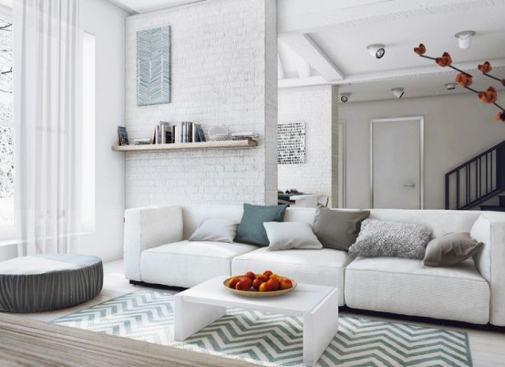 a contemporayr neutral living room with double-height windows, brick walls, neutral furniture and a floating shelf plus some prints and textures for more interest