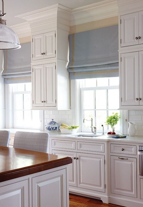 blue and yellow striped Roman shades for a vintage rustic coastal kitchen is a beautiful idea and a touch of color to the space