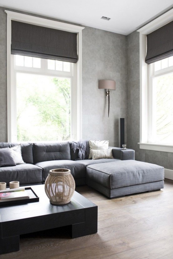 graphite grey Roman shades highlight the color scheme of the room and block the sun out very well