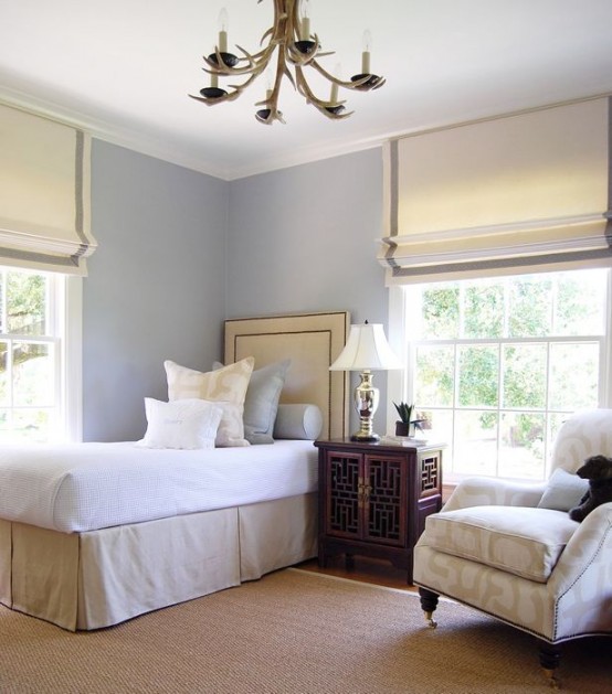 neutral and grey Roman shades highlight the elegance of the bedroom and block out the sun when needed