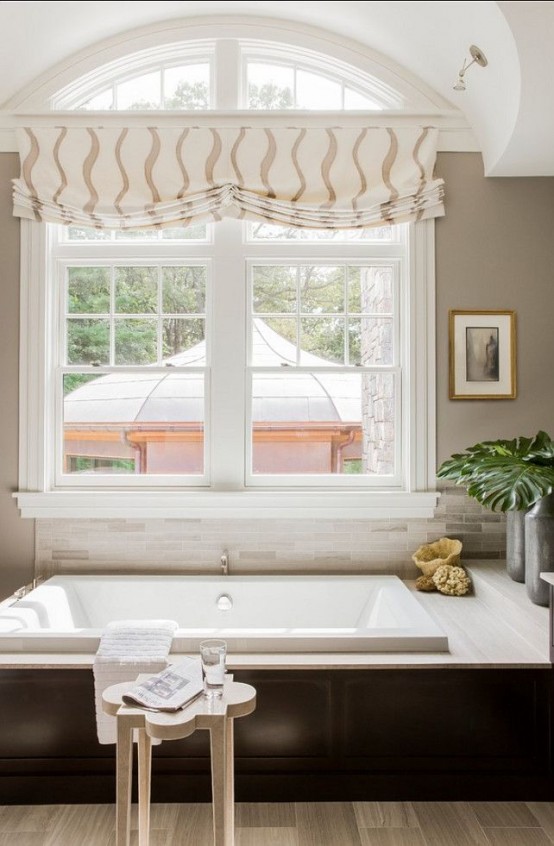 a printed Roman shade spruces up the bathroom and makes the space very cool, chic and elegant and highlight the space
