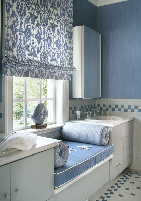 a blue and white print Roman shade is a perfect fit for this coastal bathroom and it keeps it very private and cozy
