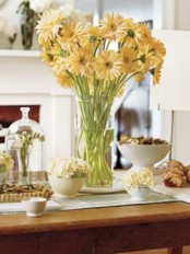 a bright yellow floral centerpiece is a great idea for a spring table setting