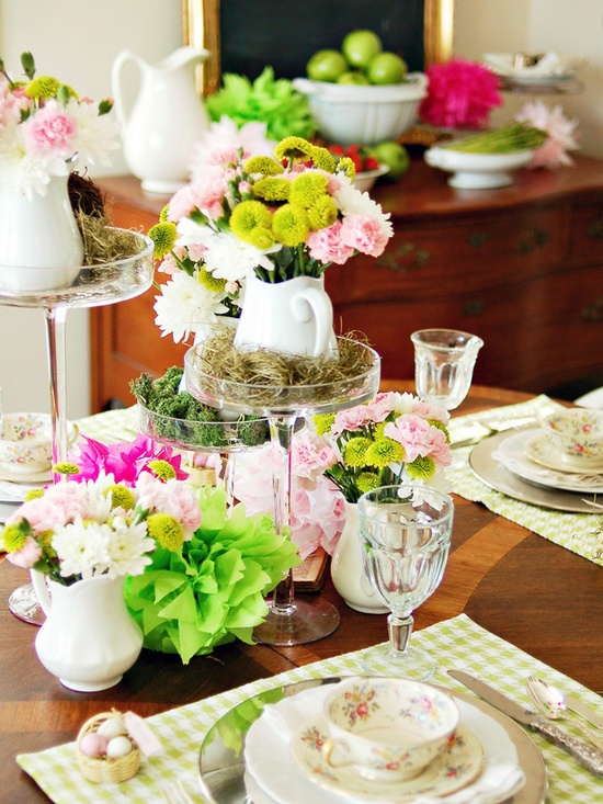a super bright spring centerpiece with pink, blush, green and yellow blooms and moss