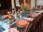a colorful spring tablescape done in orange and blues with a vintage feel
