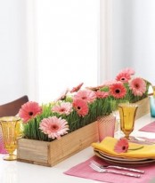 a colorful spring table setting with bright floral centerpieces, colorful napkins and glasses