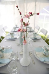 white vases with cherry blossom are perfect as spring centerpieces