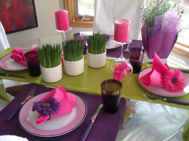 a colorful spring tablescape done in purple, pink and pistachio green plus greenery in pots