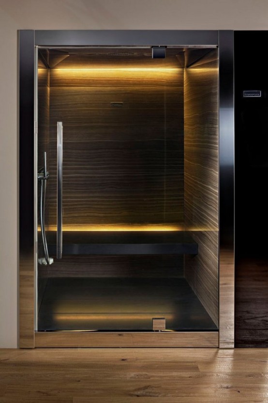 a tiny dark steam room with stone walls, a floating bench and built-in lights is very relaxing