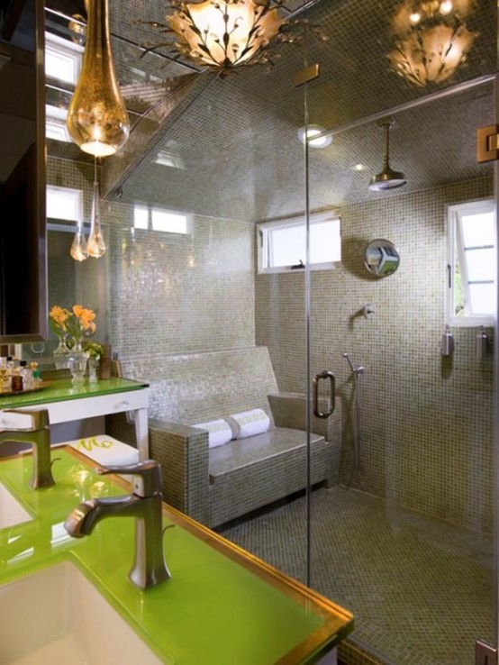 a large steam room clad with grey and green tiles, with windows and a real tile sofa for sitting