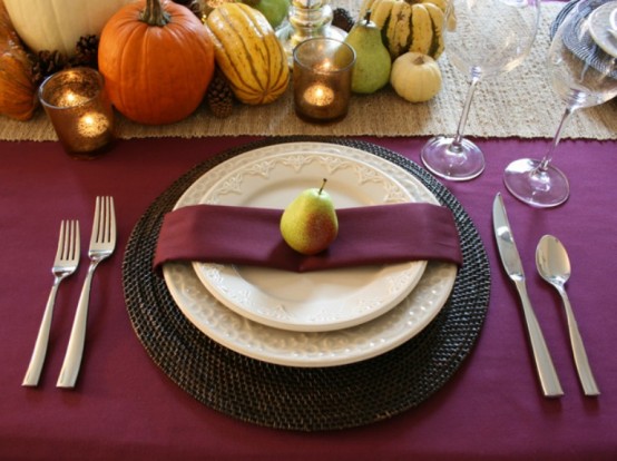 a dark woven placemat and white patterned plates plus a purple napkin compose a great contrasting Thanksgiving place setting with a touch of vintage