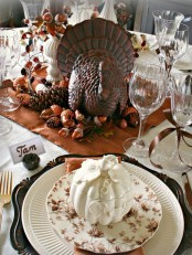 white patterned plates and a leaf and flower printed plate on top for a beautiful vintage rustic Thanksgiving tablescape