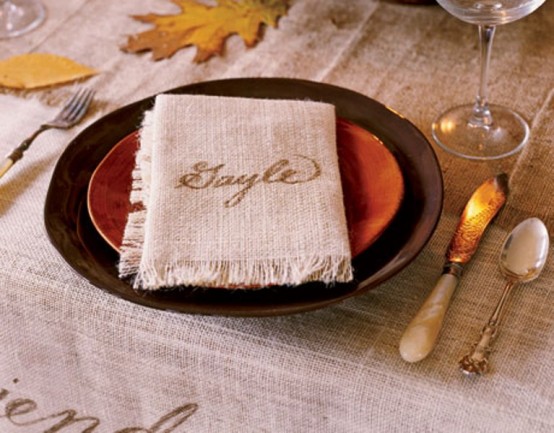 a brown and orange plate plus a simple burlap napkin for a rustic and relaxed Thanksgiving tablescape