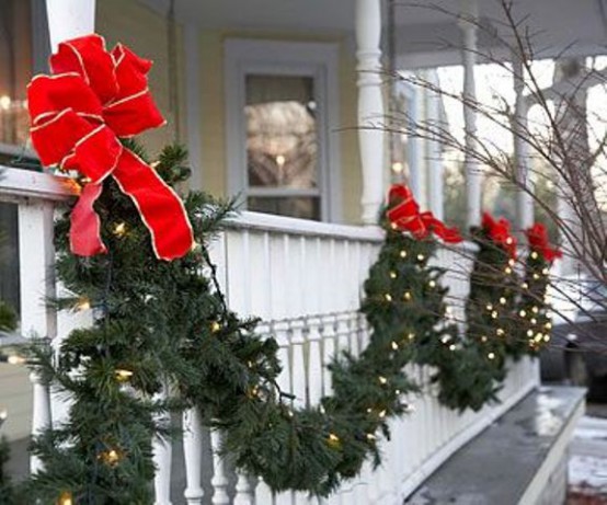 an evergreen garland with lights and red bows is a pretty outdoor decoration for Christmas, it will easily turn the exterior of your home into Christmas-like