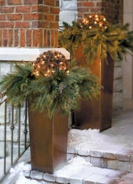 tall metallic planters with evergreens and vine balls with lights will make your porch and outdoor space holiday-like and festive