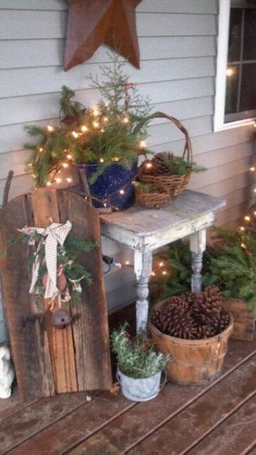 outdoor Christmas decor with evergreens, lights and pinecones is a lovely idea for a rustic space, and light will give a festive feel to the space