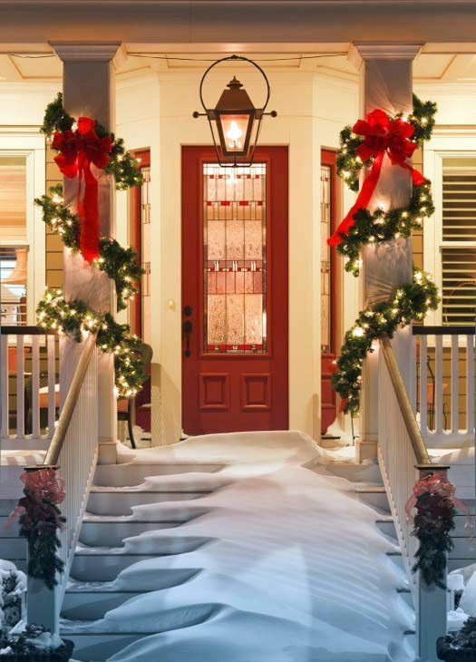 pillars wrapped with evergreen garlands, lights and with red bows will make your entrance and porch look very festive and Christmassy