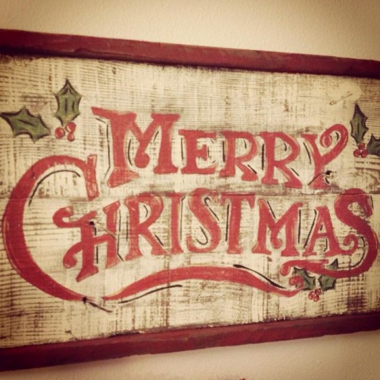 a vintage Christmas sign of a whitewashed wooden plaque and red letters plus a red frame is a stylish vintage rustic decor idea for the holidays