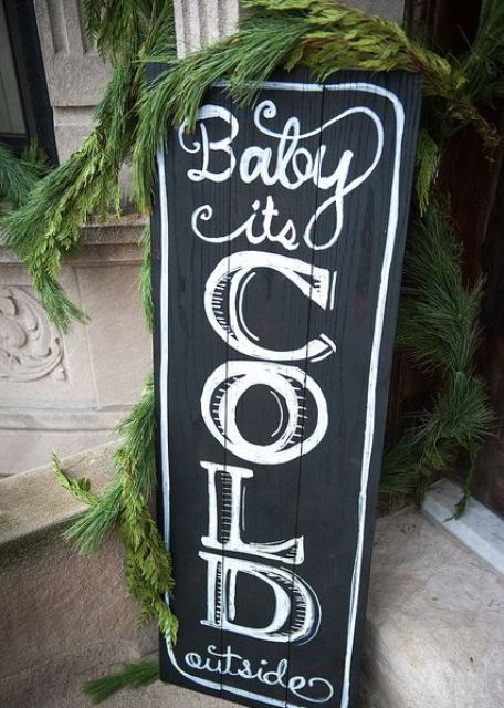 a black chalkboard Christmas sign is a nice idea for outdoors and indoors and you can change what's chalked from time to time